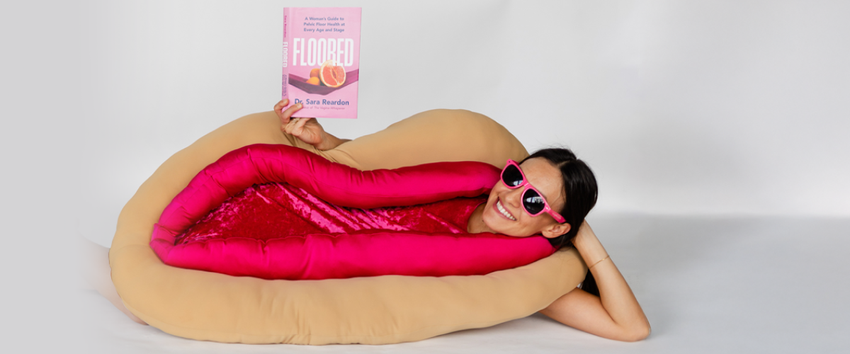 Dr Sara Reardon the Vagina whisperer holding her book wearing a vagina costume