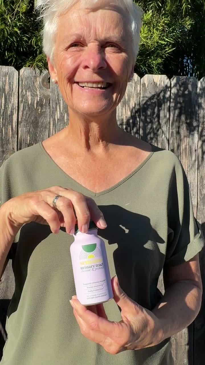 Portrait holding Urinary Tract Cleanse & Protect outdoors